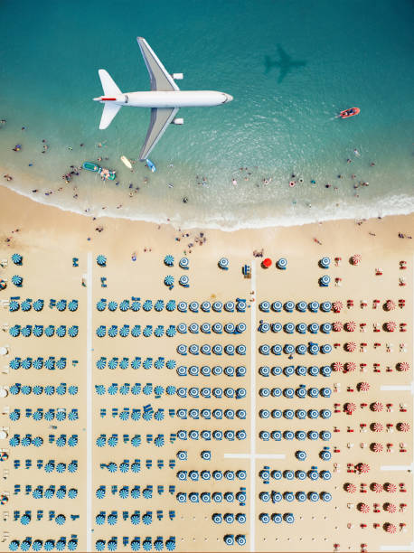istock Aerial view airplane flying over the beach 980096772
