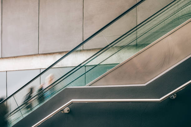 Blurred motion of people on escalator with copy space - toned image