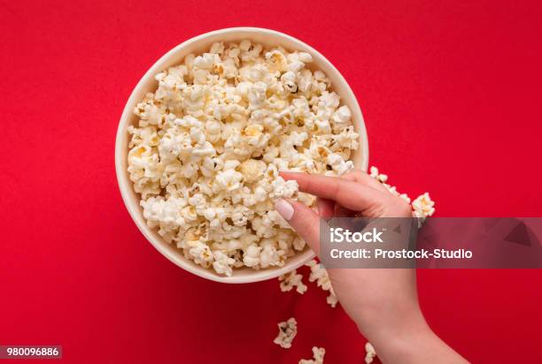 Bucket Of Popcorn On Red Background Top View Stock Photo - Download Image Now - Popcorn, Movie, Red