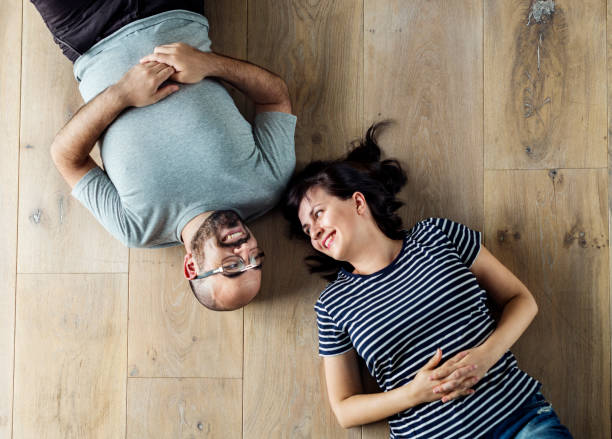 istock Family lying on wooden floor 980105888