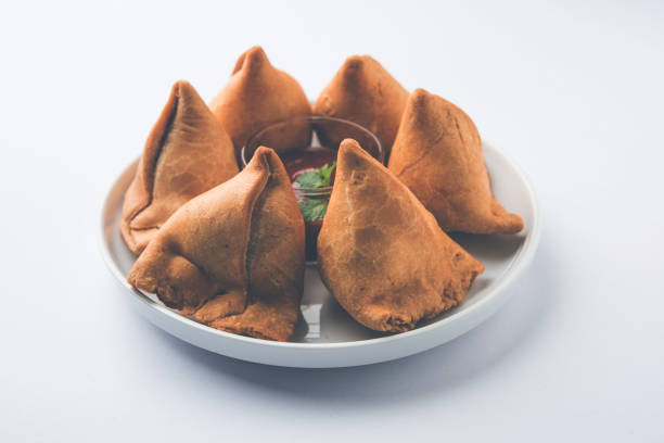 istock Samosa snack served with tomato ketchup and mint chutney 980105914