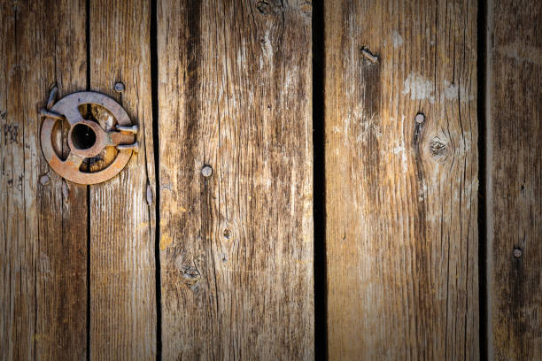 istock Original vintage background from wooden boards with nails and an iron disk 980106196