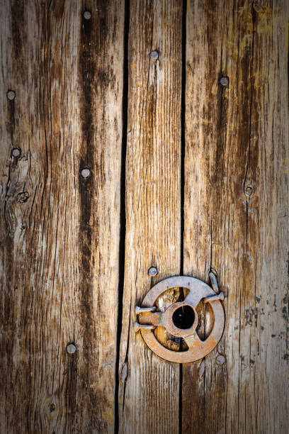 istock Original vintage background from wooden boards with nails and an iron disk 980106554