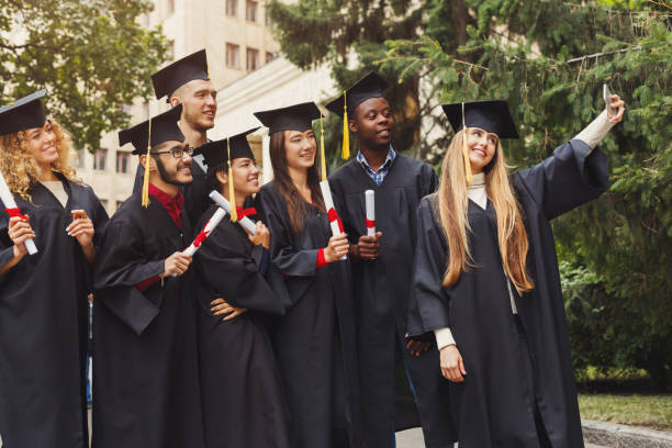 istock Group of graduates celebrating and making selfie 980106570