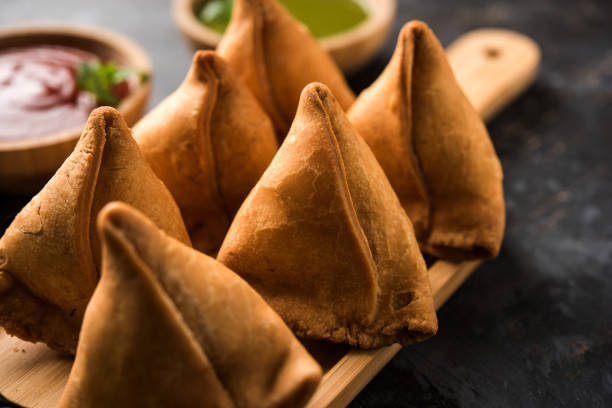 istock Samosa snack served with tomato ketchup and mint chutney 980106952