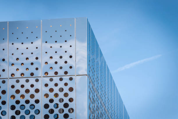 istock Morning view reflecting shiny modern building surface on blue sky in background 980118406