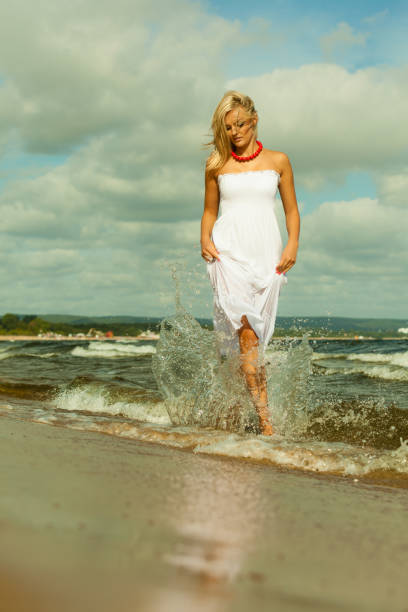 istock Beautiful blonde girl on beach, summertime 980121886