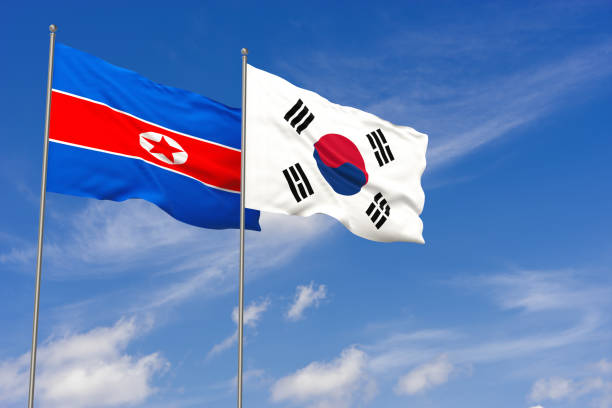 Two realistic waving National flags of South Korea and North Korea stock photo