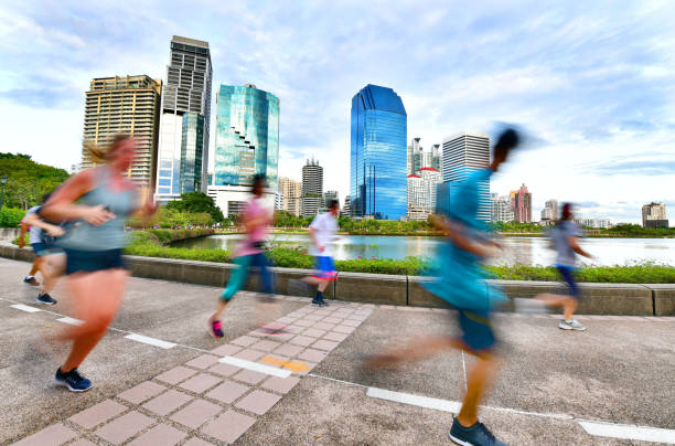 istock People running in the evening at park 980127914