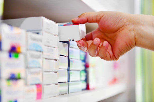 Hand holding medicine box in pharmacy drugstore. stock photo