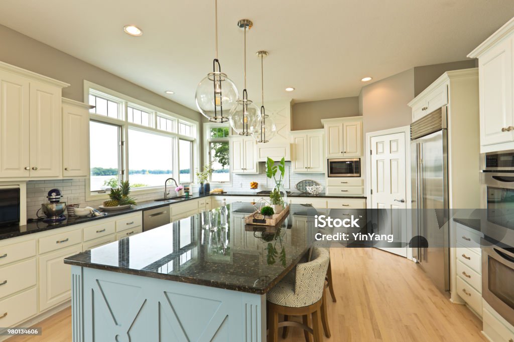 Modern Kitchen design with open concept and bar counter +++NOTE TO INSPECTOR: Photo artwork in kitchen is taken by me, see property release.+++

A contemporary kitchen with open concept design and bar counter in a modern home. Kitchen Stock Photo