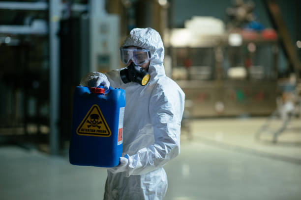 istock Factory worker wearing gas mask and radioactive protection suit 980135456