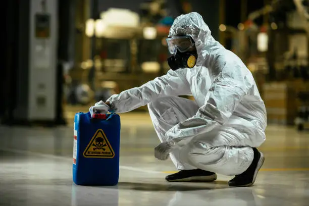 Photo of Factory worker wearing gas mask and radioactive protection suit