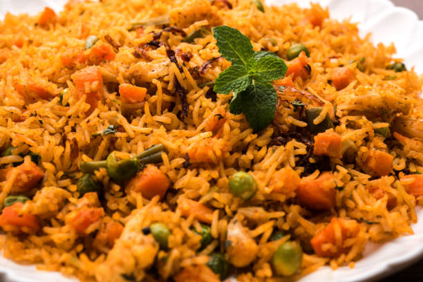 istock Indian Vegetable Pulav or Biryani made using Basmati Rice, served in terracotta bowl. selective focus 980135854