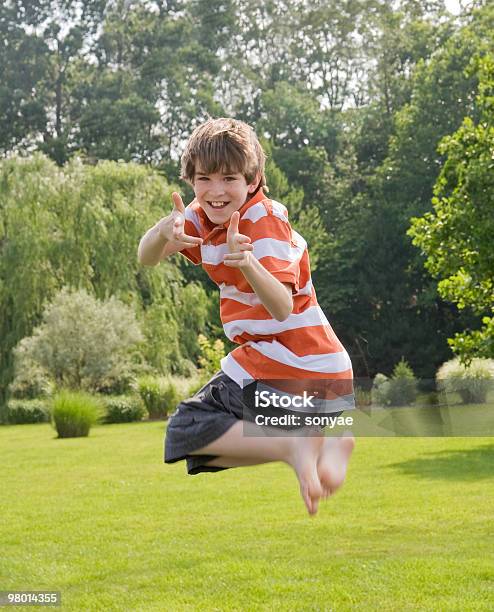Boy Jumping In The Air Stock Photo - Download Image Now - Adolescence, Boys, Cheerful