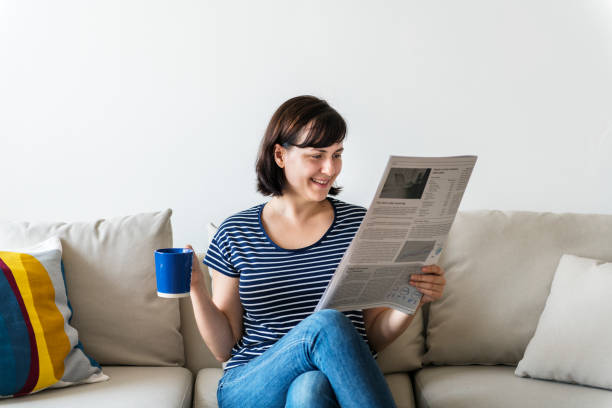 istock Woman reading newspaper 980152226