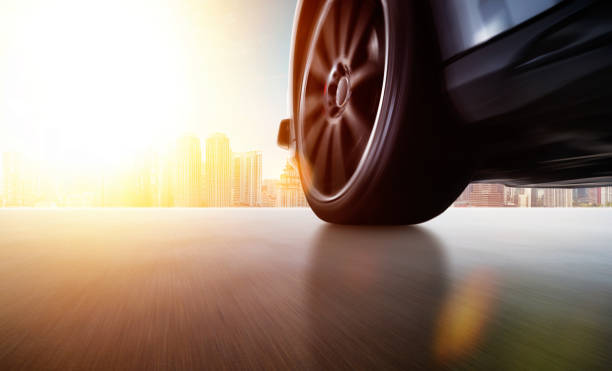 istock Low angle side view of car driving fast 980152384