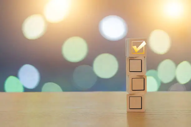 Check your choice on 4 wooden cubes on a beautiful bokeh background with lights