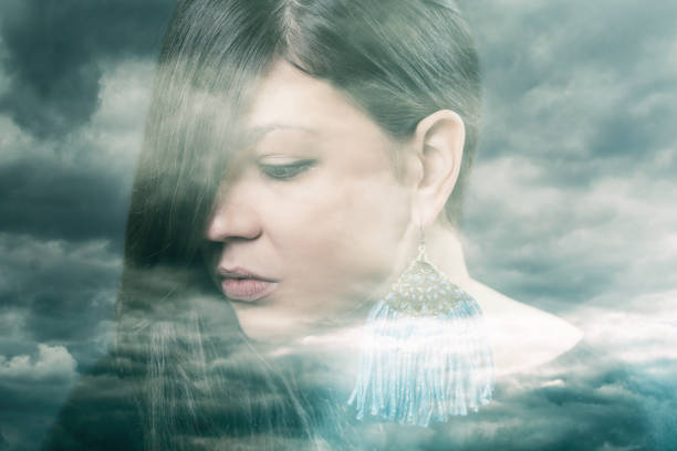 istock Double exposure of a woman with dramatic sky 980182486