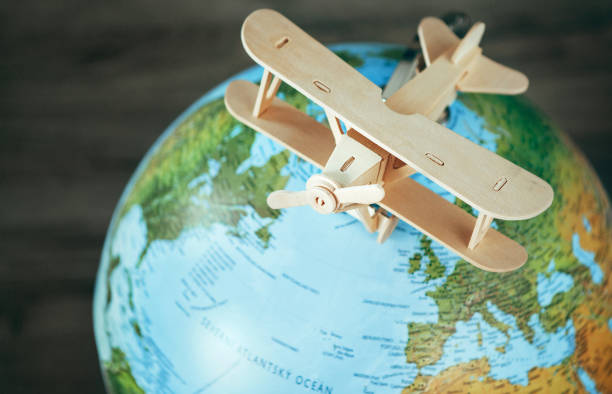 istock Wooden plane model is on the earth globe. Travel concept image 980186432