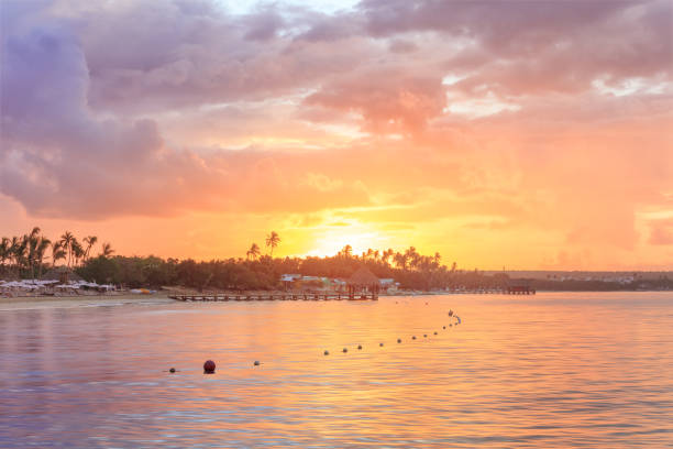 Sunset beach of La Romana, Dominican Republic with long wooden pier
