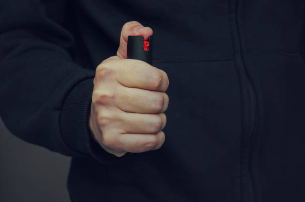 istock A man's hand holding a small bottle of pepper spray 980191570