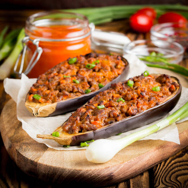 istock Stuffed eggplant, aubergine, ground beef, pork, vegetables, tomato sauce, rustic style 980197328