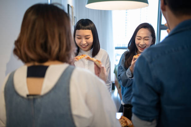 istock 4 friends gathering at home for a quick meal 980203496