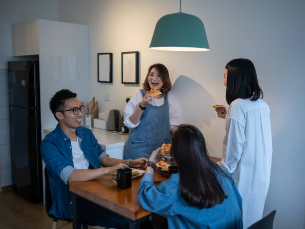 istock 4 friends gathering at home for a quick meal 980203746