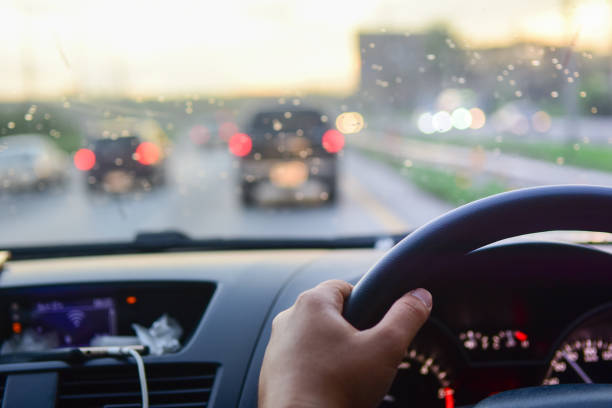 istock Man driving car from rear view on the highway With sunlight. 980204480
