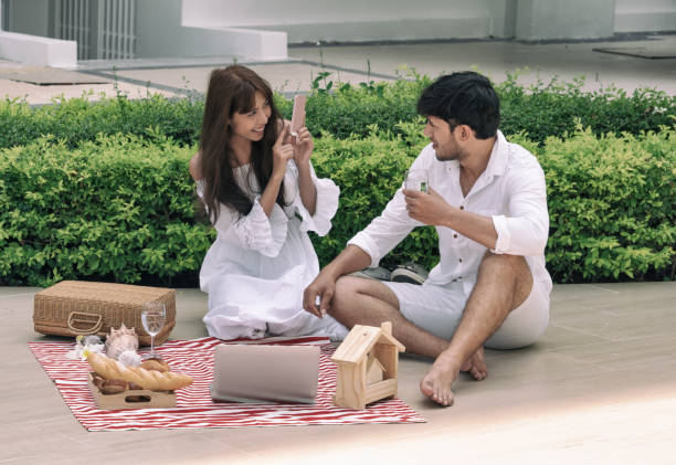 istock Young couple picnic  in the park 980220346