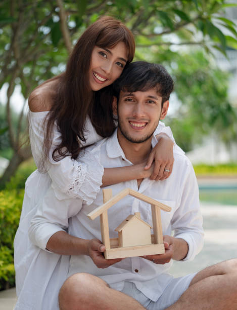 istock couple with small wooden house 980220420