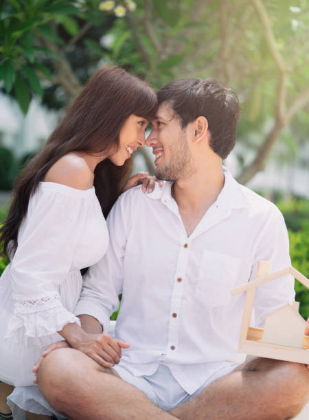 istock couple with small wooden house 980220450