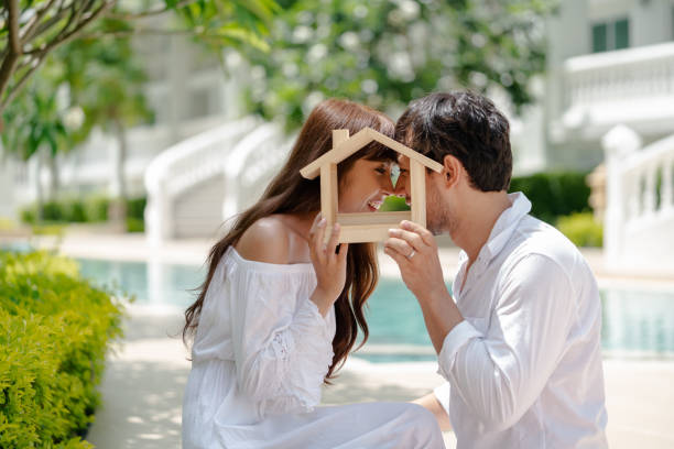 istock couple with small wooden house 980220518