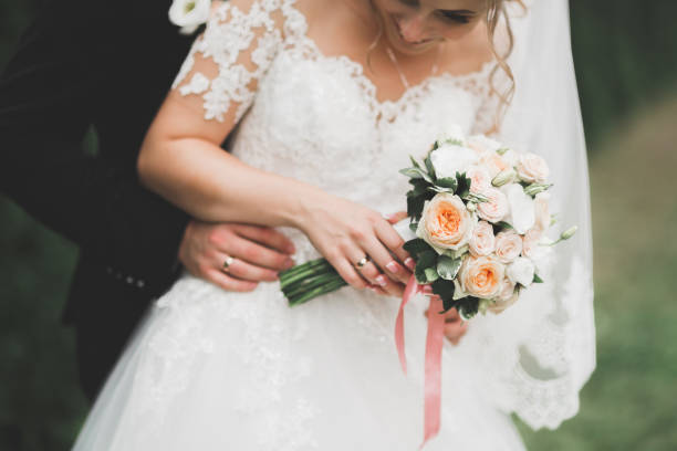 istock Bride holding big and beautiful wedding bouquet with flowers 980224488