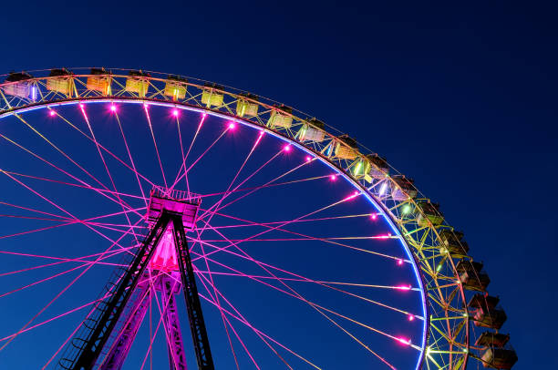 istock Big ferris wheel with festive colorful illumination 980229956