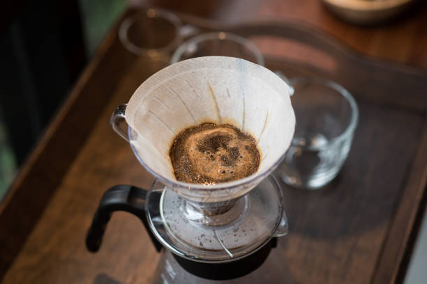 istock Barista pouring water on coffee ground with filter ; Hand drip coffee 980233304