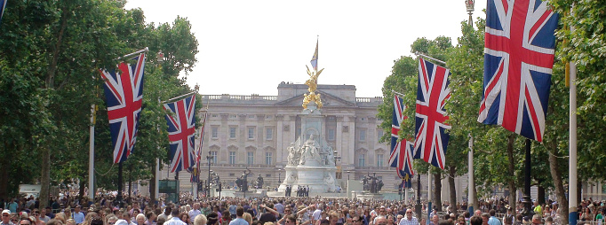 View Of Buckingham Palace, Police Officers Standing, British Flag Waving, Lots Of People Walking Around, Looking Around, Taking Picture, Talking To One Another After British Traditional Trooping The Colour Marching Parade During Queen Elizabeth ii Official Birthday Ceremony In Westminster London England Europe