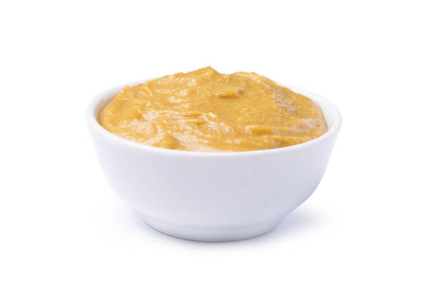 istock Tasty sauce mustard in bowl isolated on white background 980236430