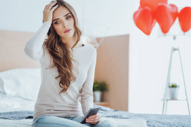 istock Nice cheerless woman touching her head 980240386
