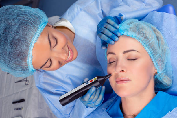 Woman having a non surgical procedure to remove nasolabial wrinkles stock photo