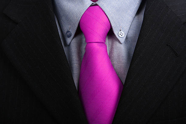 istock Close up of a bright fuchsia tie under a black suit 98024980