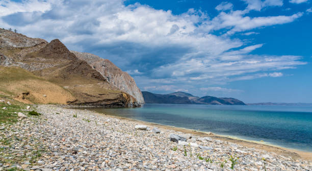 istock rock and pebble beach on lake Baikal 980252652