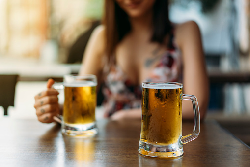 Young Woman Drinking Beer