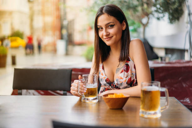 istock Young Woman Drinking Beer 980255392