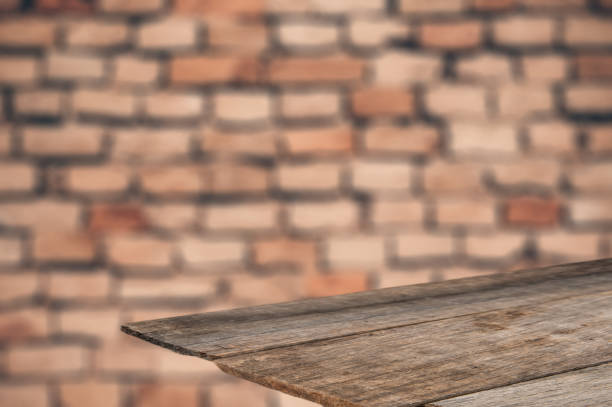 istock Emty wooden table in front of brick wall 980259308