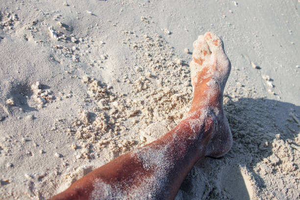 istock Sandy mens feet on the sandy beach 980260208