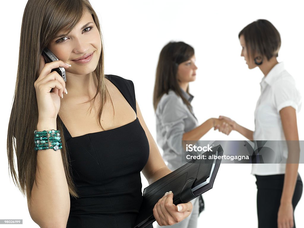 young businesswoman with colleagues in the background  Adult Stock Photo