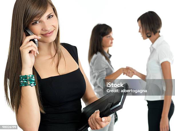 Young Businesswoman With Colleagues In The Background Stock Photo - Download Image Now