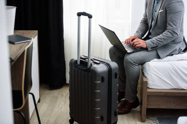 istock Businessman using laptop computer, working at his hotel room 980262622